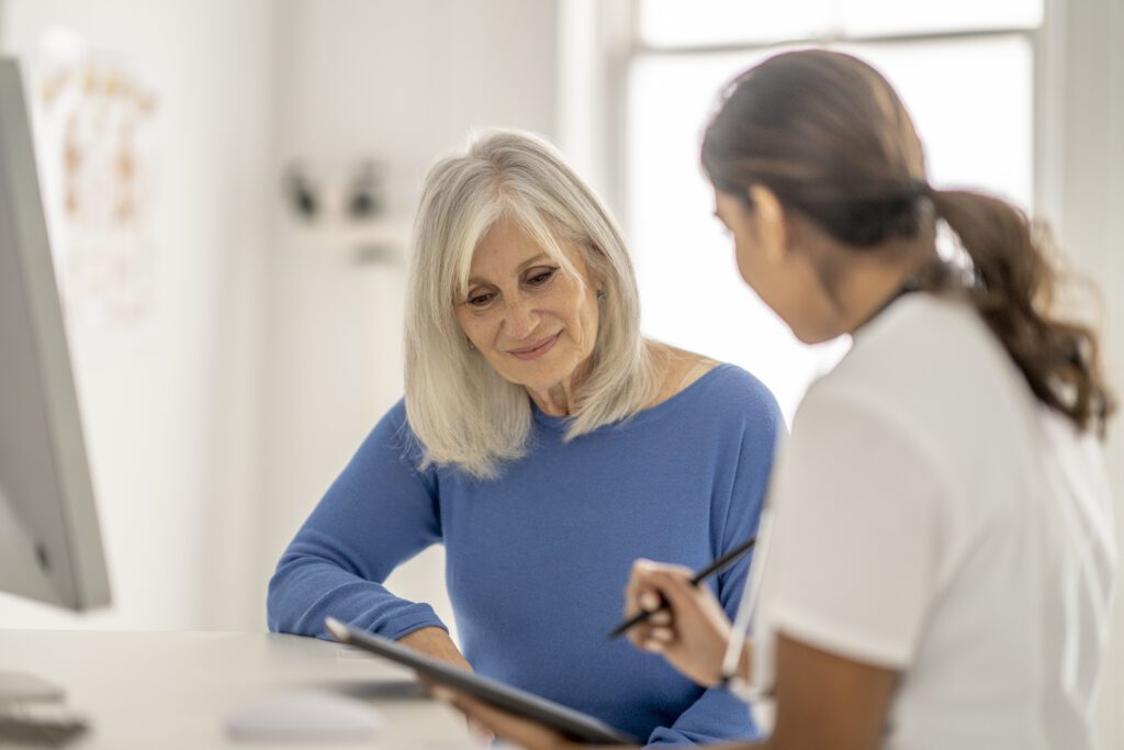 Senior woman consulting with a healthcare professional.